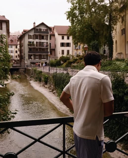 Joseph overlooking a canal lined with houses and trees